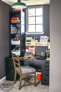 a desk and chair in a room with a book shelf on the far wall next to it