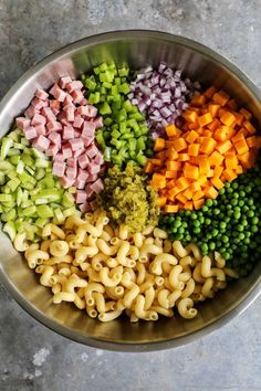 a bowl filled with different types of pasta and vegetables