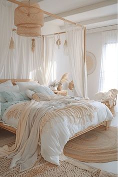 a bed with white sheets and pillows in a room next to two wicker chairs