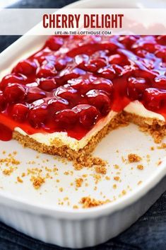 a dessert with cherries on top in a white dish, ready to be eaten