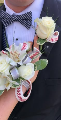 a close up of a person wearing a suit and tie holding flowers in their hands