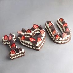 three pieces of chocolate cake with strawberries on top