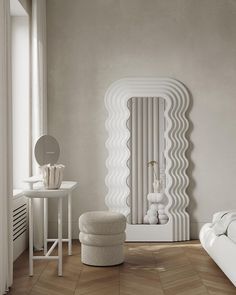 a white room with an unusual mirror and stool on the floor next to a table