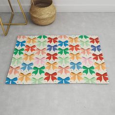 a multicolored rug on the floor next to a basket