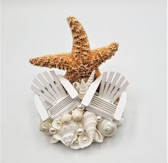 a starfish sitting on top of a pile of beach chairs and seashells