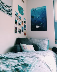 a bed sitting in a bedroom next to two pictures on the wall