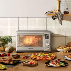 a microwave oven sitting on top of a counter filled with pizzas and other food