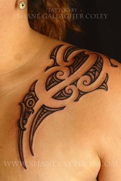 a woman's chest with a tattoo design on the upper part of her breast