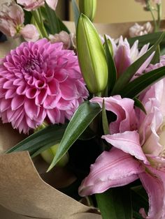 a bouquet of pink flowers sitting on top of a table