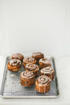 cinnamon rolls on a cooling rack ready to be baked