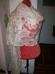 "Amazing Blonde lace shawl is of a delicate lightweight drape that can be worn in different ways. This is an antique but yet it is strong and in excellent condition. This would be a lovely shawl or even a short veil for a bride. silk, wonderful design. An heirloom to keep and wear. width 25\" at widest point length 100\"" Bohemian Lace Shawl In Cream Color, Wedding Lace Shawl With Lace Trim, Elegant Cream Lace Shawl, White Vintage Shawl Scarves, Luxury Romantic Lace Shawl, Short Veil, Alencon Lace, Lace Shawl, Antique Lace