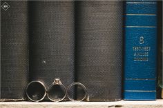 three wedding rings sitting on top of two books