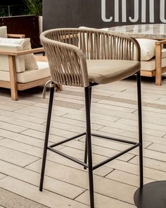 a chair sitting on top of a wooden floor next to a table with chairs around it