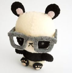 a stuffed panda bear with glasses on it's head