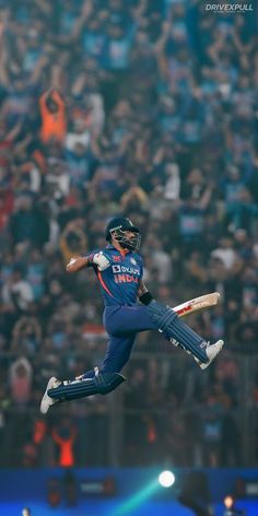 a cricket player is in mid air after hitting the ball