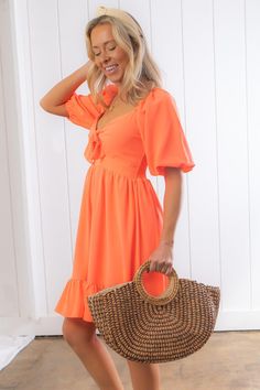 Get ready to make a lasting impression with the Nour Orange Creamsicle Mini Dress. This dress is all about fun and flirty vibes with its vibrant creamsicle hue and irresistible sweetheart neckline. The flowy and free silhouette adds an alluring appeal, while the smocked back ensures a comfortable fit. With front bow detailing, this dress adds a charming touch to your ensemble. Style it with wedges and statement jewelry for a trendy and complete look that is perfect for any occasion. Whether it's Flirty Midi Dress With Sweetheart Neckline For Brunch, Sweetheart Neckline Midi Dress For Beach, Trendy Mini Dress With Sweetheart Neckline For Spring, Flirty Beach Dress With Sweetheart Neckline, Orange Summer Midi Dress With Ruffles, Summer Midi Dress With Sweetheart Neckline For Beach, Chic Beach Dress With Sweetheart Neckline, Trendy Summer Dresses With Sweetheart Neckline, Chic Midi Dress With Sweetheart Neckline For Vacation