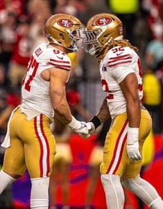 two football players standing next to each other