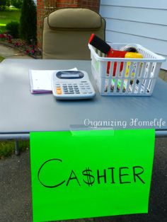 a green sign sitting on top of a table with a calculator next to it