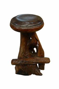 a wooden stool with a leather seat on it's backrest and foot rest