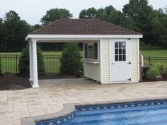 a pool with a gazebo next to it and a swimming pool in the background