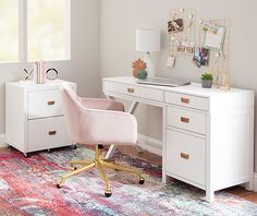 a pink chair sits in front of a white desk with a colorful rug on it