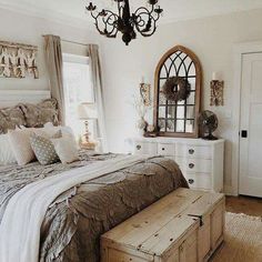 a bed room with a neatly made bed next to a window and a wooden dresser