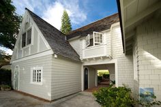 a white house with a black roof and windows