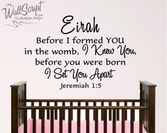 a baby crib with a wall decal that says, even before i formed you in the womb