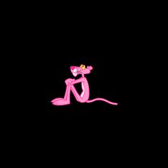 a pink cartoon character sitting on the ground