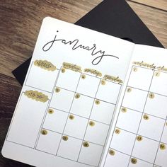 a planner with gold foil on it and the word january written in cursive writing