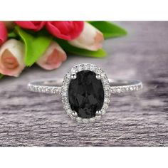 an oval cut black diamond ring with diamonds around it