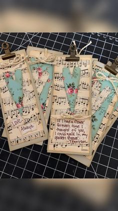 three tags with music notes on them sitting on top of a sheet of musical paper