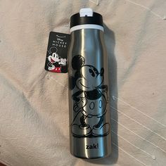 a stainless steel water bottle with a mickey mouse sticker on it