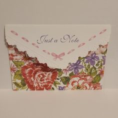 a card with flowers on it that says just a note