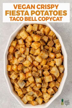 a white bowl filled with fried potatoes on top of a gray counter next to the words vegan crispy fiesta potatoes taco bell copycat