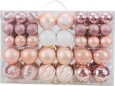 a clear box filled with pink and gold christmas bauble ornament balls