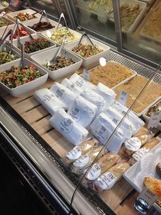 a display case in a store filled with lots of food and condiments on it