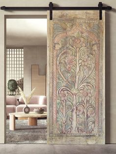 an ornately decorated door is open to the living room