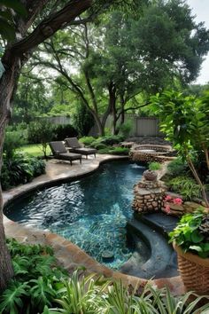 an outdoor swimming pool surrounded by trees and plants