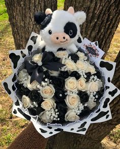 a stuffed animal is sitting in a bouquet