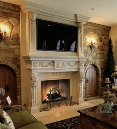 a living room filled with furniture and a flat screen tv mounted on the wall above a fire place