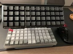 a computer keyboard sitting on top of a desk