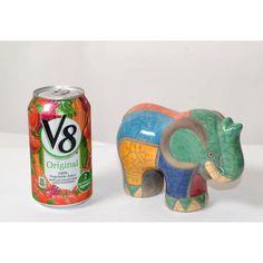 an elephant figurine next to a can of v88