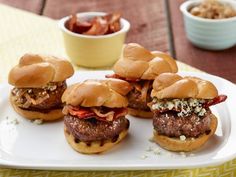 mini burgers with meat and cheese on a white plate