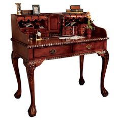 an antique desk with drawers and pictures on it