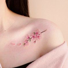 a woman's breast with pink flowers on it