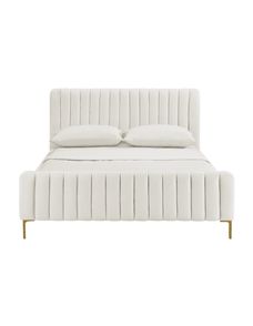 a white bed with two pillows on top of it