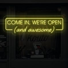 a neon sign that reads, come in, we're open and awesome now