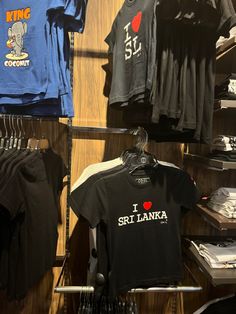 t - shirts and other items are on display in a clothing store's closet