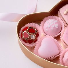 a heart shaped box filled with pink and white chocolates